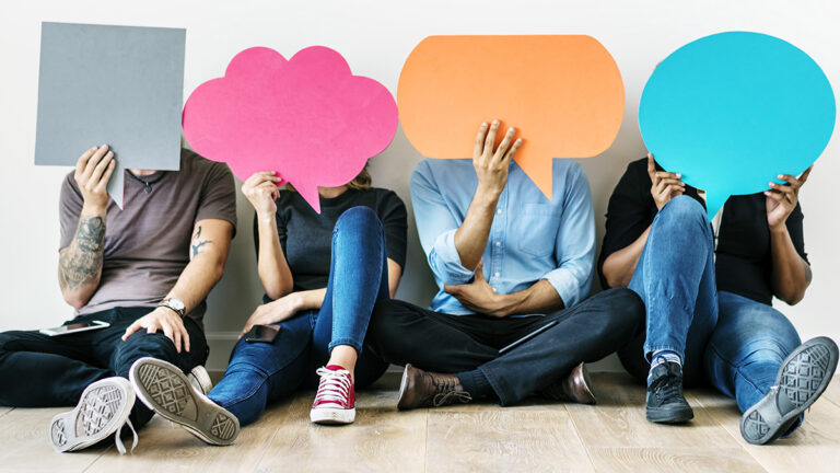 People holding colourful speech bubbles for online questions and answers
