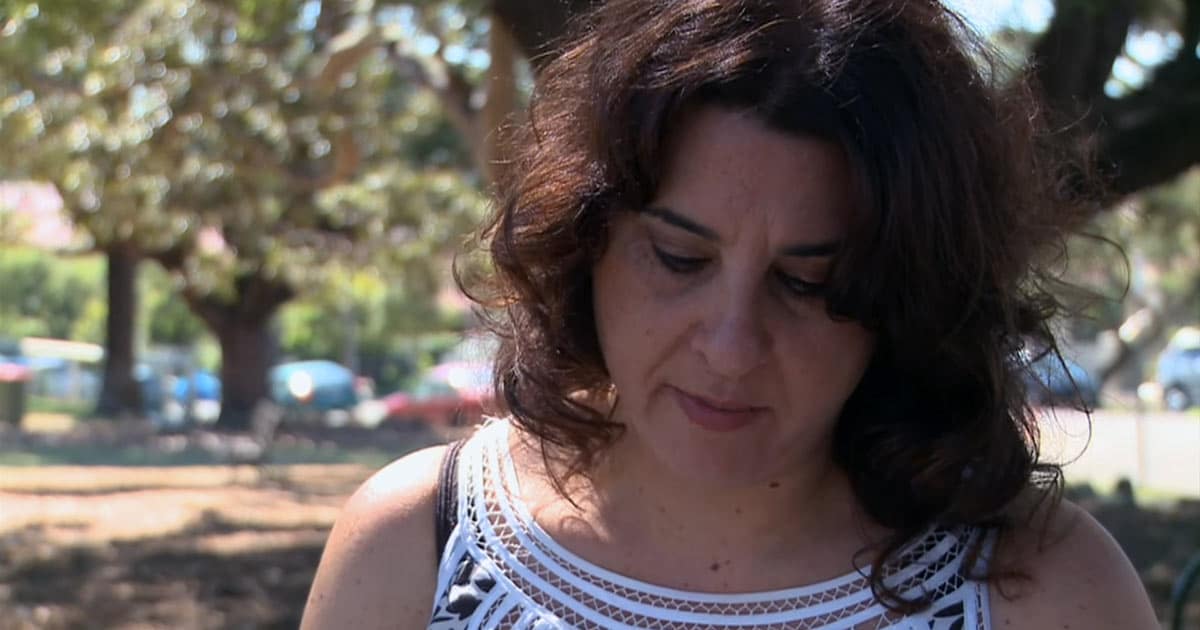 Melina Marchetta reading in a park in 2010