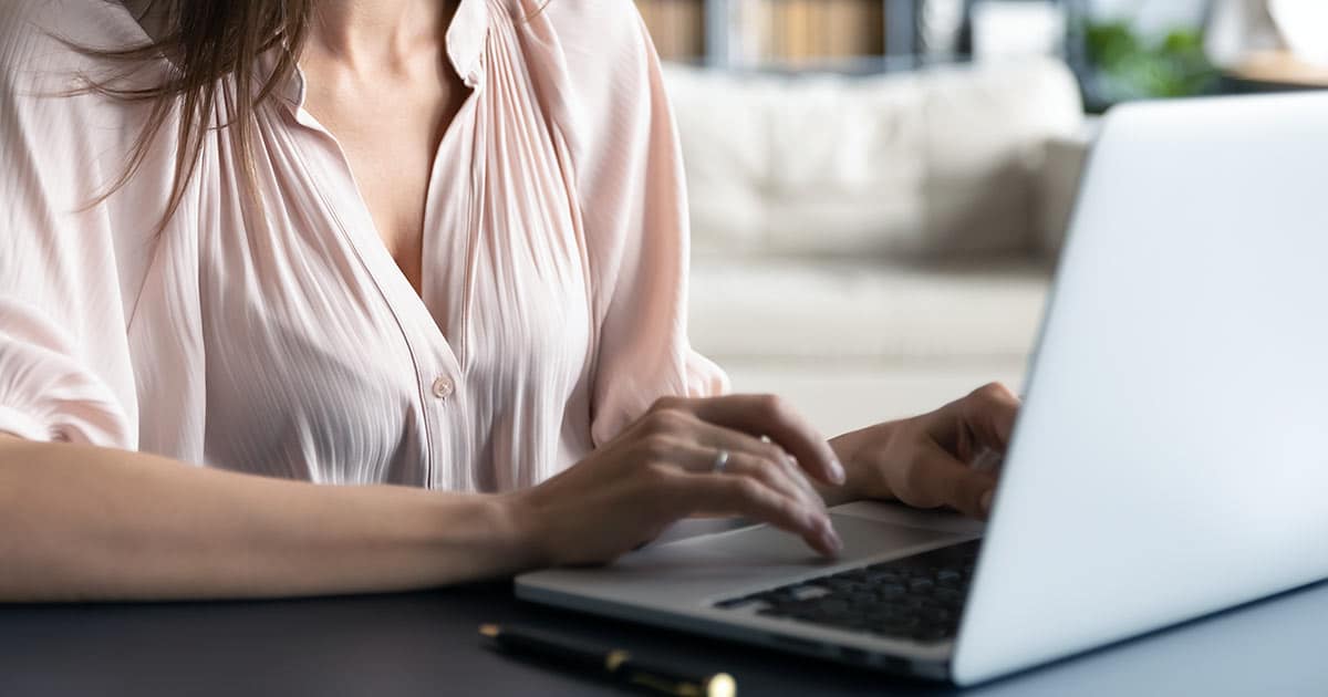 Young woman typing on laptop